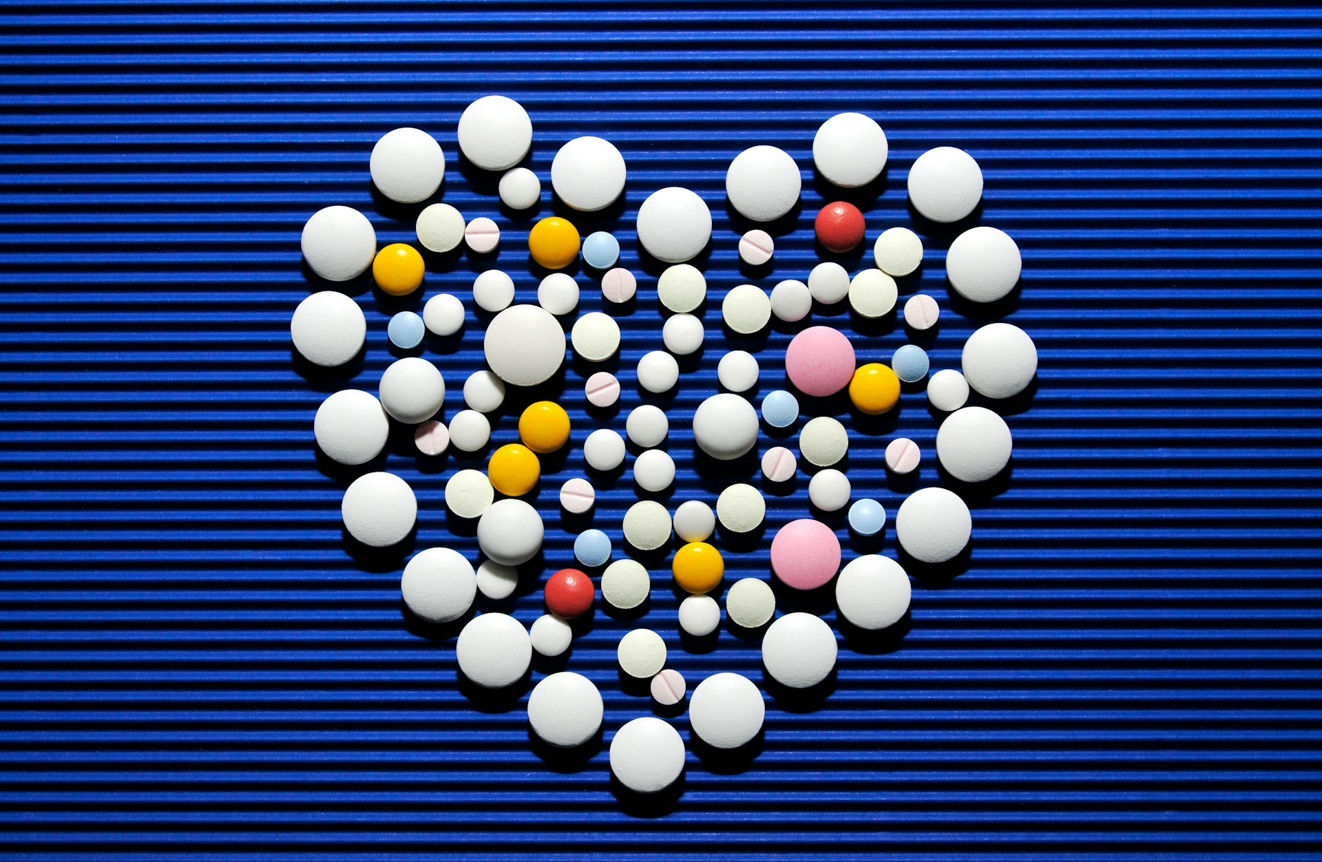 A heart made out of pills on a blue background